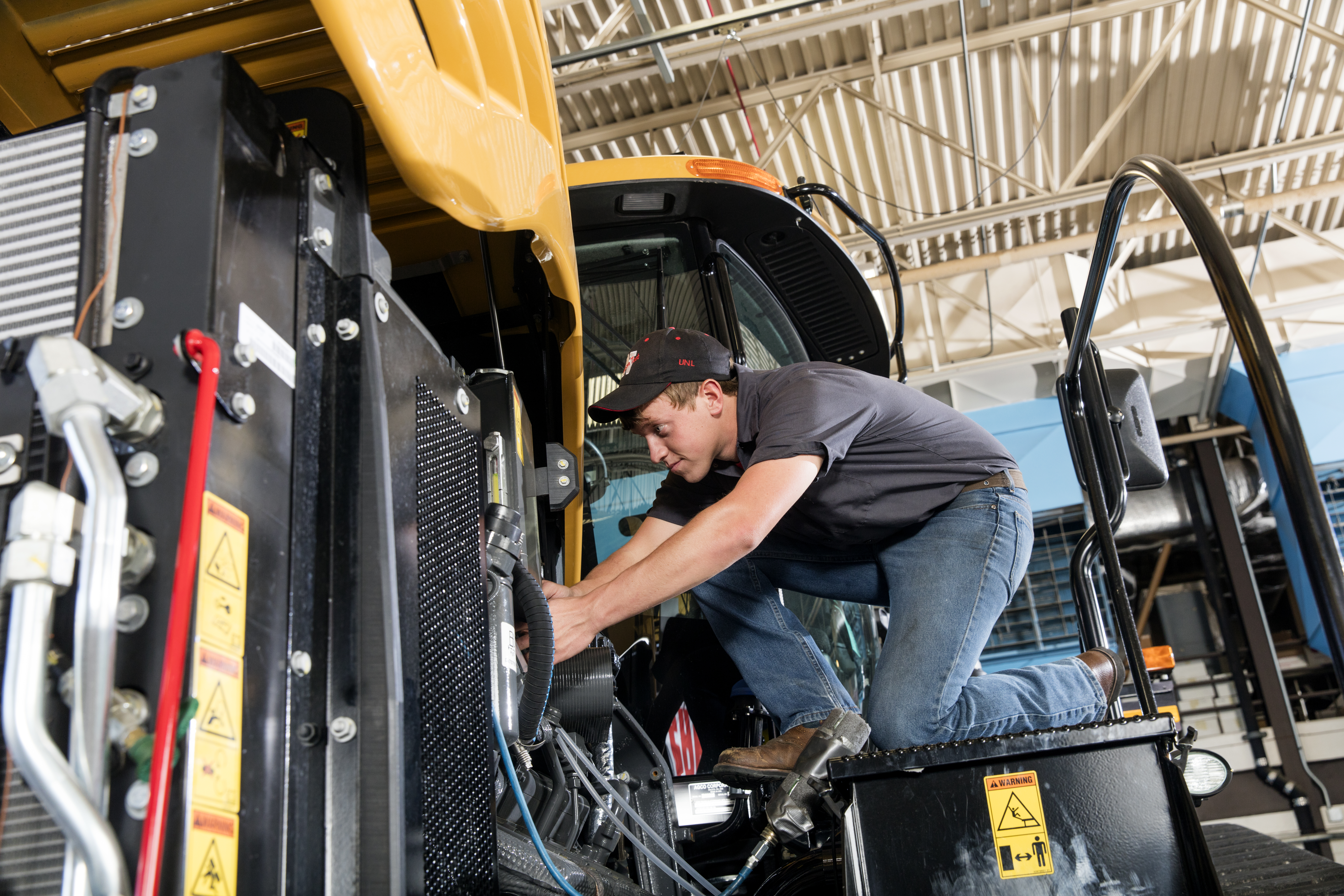 Devon Vancura, a senior agricultural engineering major, checks a connection for a testing monitor in the Nebraska Tractor Test Laboratory. The facility is the designated tractor testing station for the entire United States.