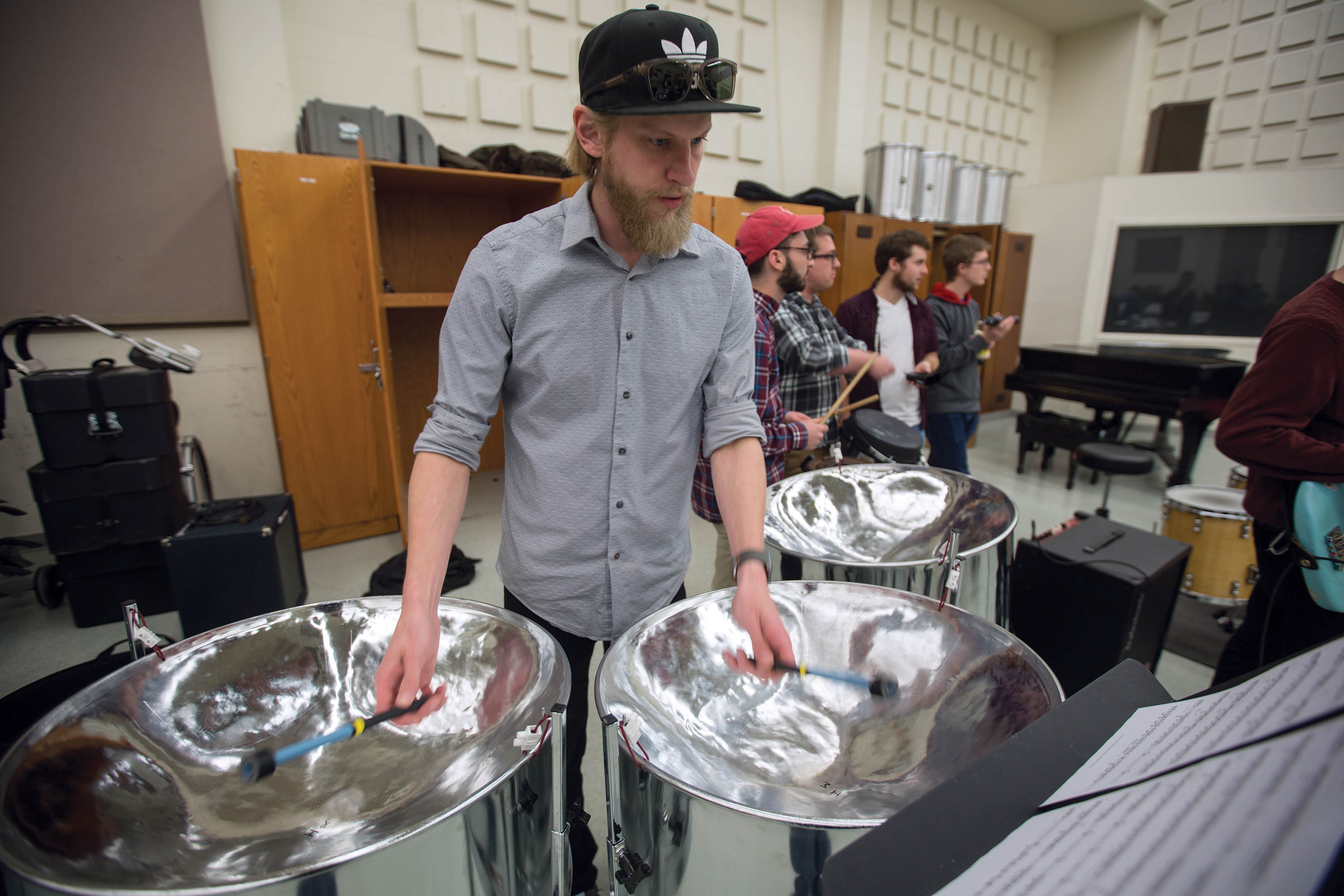 Mike Roe, a graduate student in music, plays a cello (guitar) pan during practice in Westbrook Music Building. Nebraska Steel includes 22 student performers. The ensemble includes two performance groups that can play together or separately.