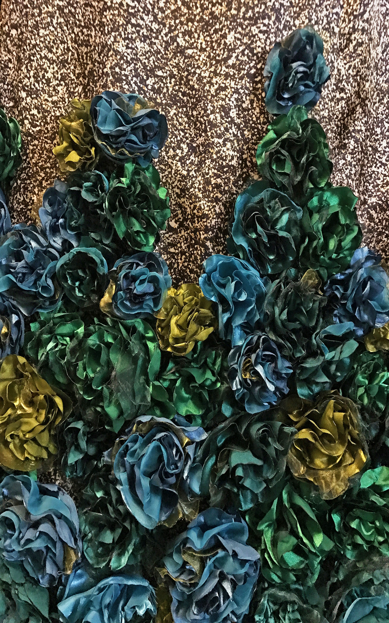 Detail showing satin flowers as textile manipulation in the garment "Riqueza," 2017, by Katherine Rodriguez Hernandez.