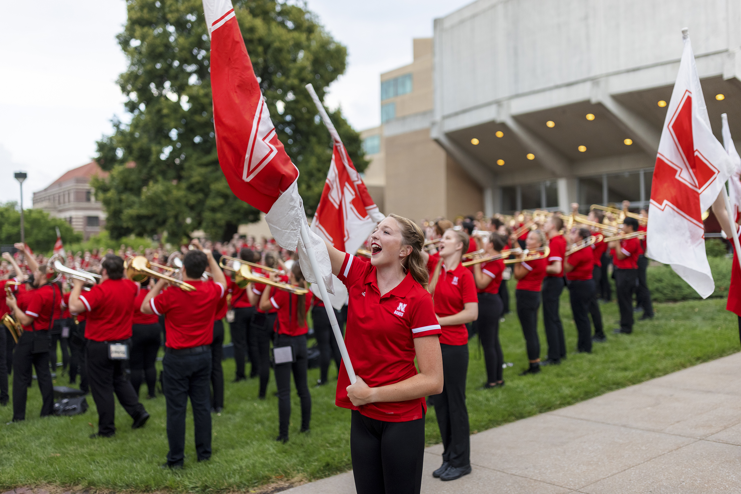 Color guard member Haley Petri chants “Go Big Red” during the Cornhusker Marching Band’s warm-up concert north of Kimball Recital Hall on Aug. 20. The band then marched to Memorial Stadium for its annual exhibition before it was canceled due to lightning. The band will make its 2021 debut Sept. 4 at the stadium with pregame and halftime performances at Nebraska's football home opener against Fordham.