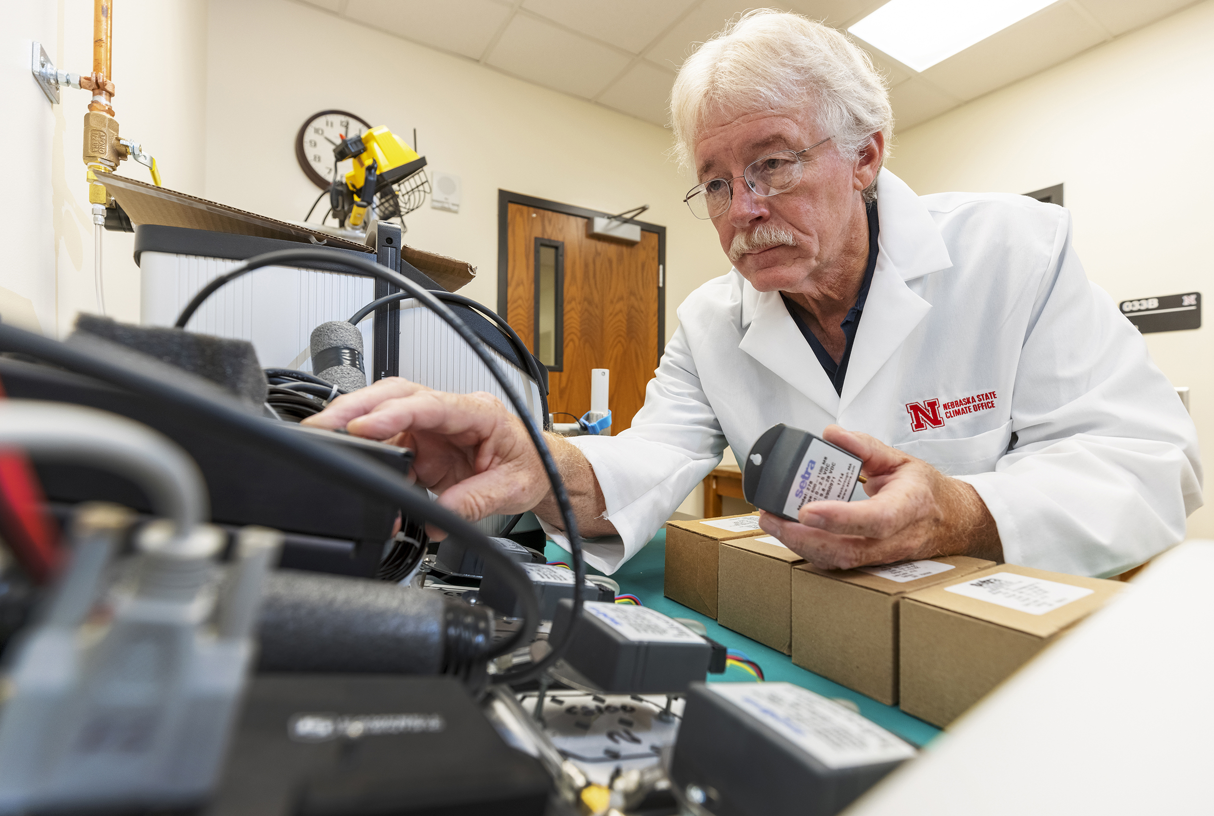 Senior Nebraska Mesonet technician Glen Roebke runs tests on a set of weather station barometers. A new sensor calibration lab has been developed by the Nebraska State Climate Office in Nebraska’s School of Natural Resources.