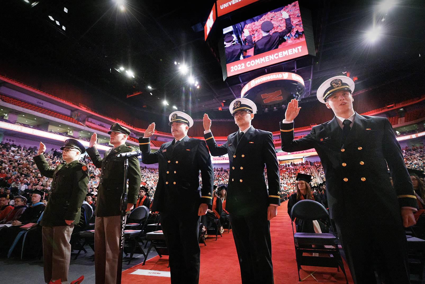 Five Army and Naval ROTC graduates repeat the oath of office during the undergraduate commencement ceremony Dec. 17 at Pinnacle Bank Arena. They are (from left) 2nd Lts. Jack O’Dell and Aubrey Fangmeier, Army; and Ensigns Cohan Bonow, John Carpenter and Nathan Hills, Navy.