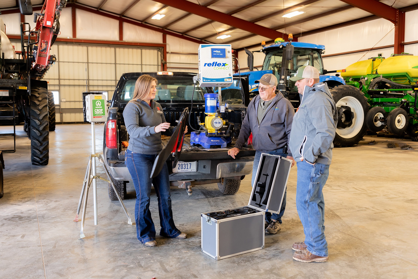 Taylor Cross (left), a graduate student in mechanized systems management, describes to Nebraska ag producers Doug Jones (center) and Tony Jones how drones use multrispectral imagery to detect nitrogen levels that enable precise nitrogen application.