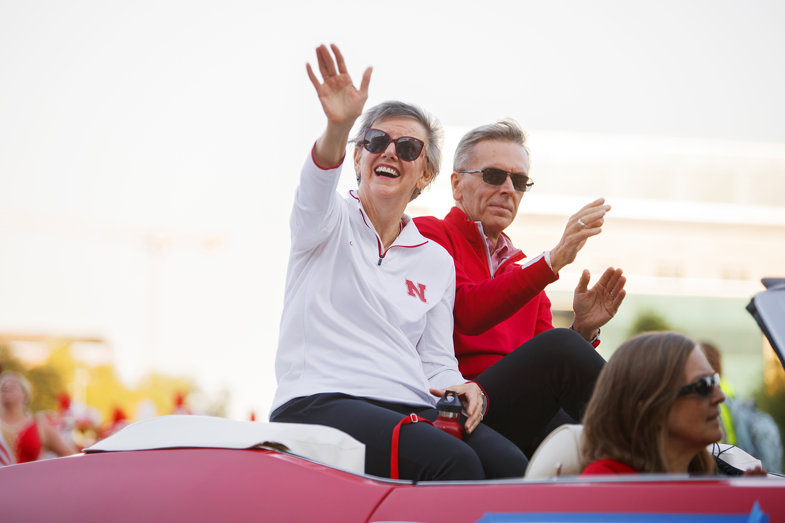 Ronnie and Jane Green ride in a convertible during Nebraska's 2022 Homecoming Parade.