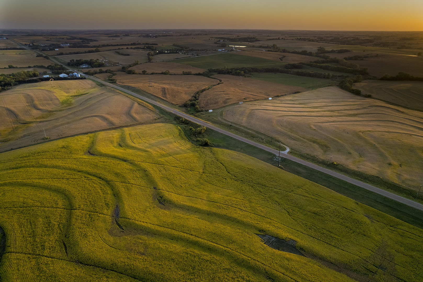 Corn and soybean fields create a patchwork of colors at sunset, bisected by Highway 43 in southeast Lancaster County. The market value of agricultural land in Nebraska increased 14% over the prior year, to an average of $3,835 per acre, according to a University of Nebraska–Lincoln report.