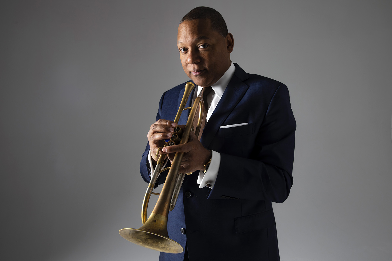 Color portrait of Wynton Marsalis holding a trumpet