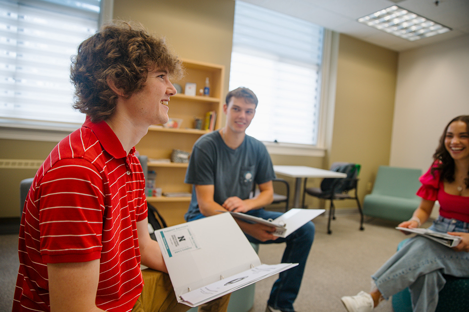 (From left) CARE Peer Educators Trent Rood, James Jura and Lydia Storm discuss hosting SARV workshops for students around campus.