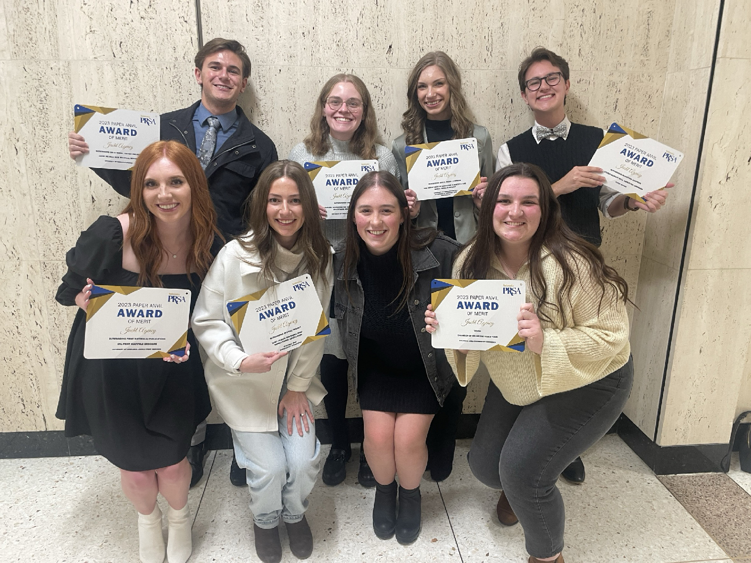 The Jacht Agency won seven awards of merit during the Paper Anvil Awards, presented by the Nebraska chapter of the Public Relations Society of America on Dec. 7. Jacht members include (back row, from left) Noah Hass, Kara Stone, Breanna Fanta and Drew Baldrige; (front row, from left) Sara Schulz, Paige Brophy, Caroline Oberle and Abby Reed.