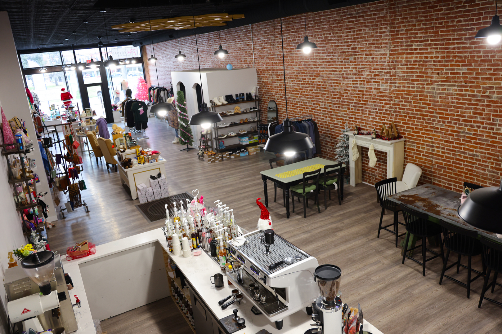 A boutique and coffee shop with tables for customers.