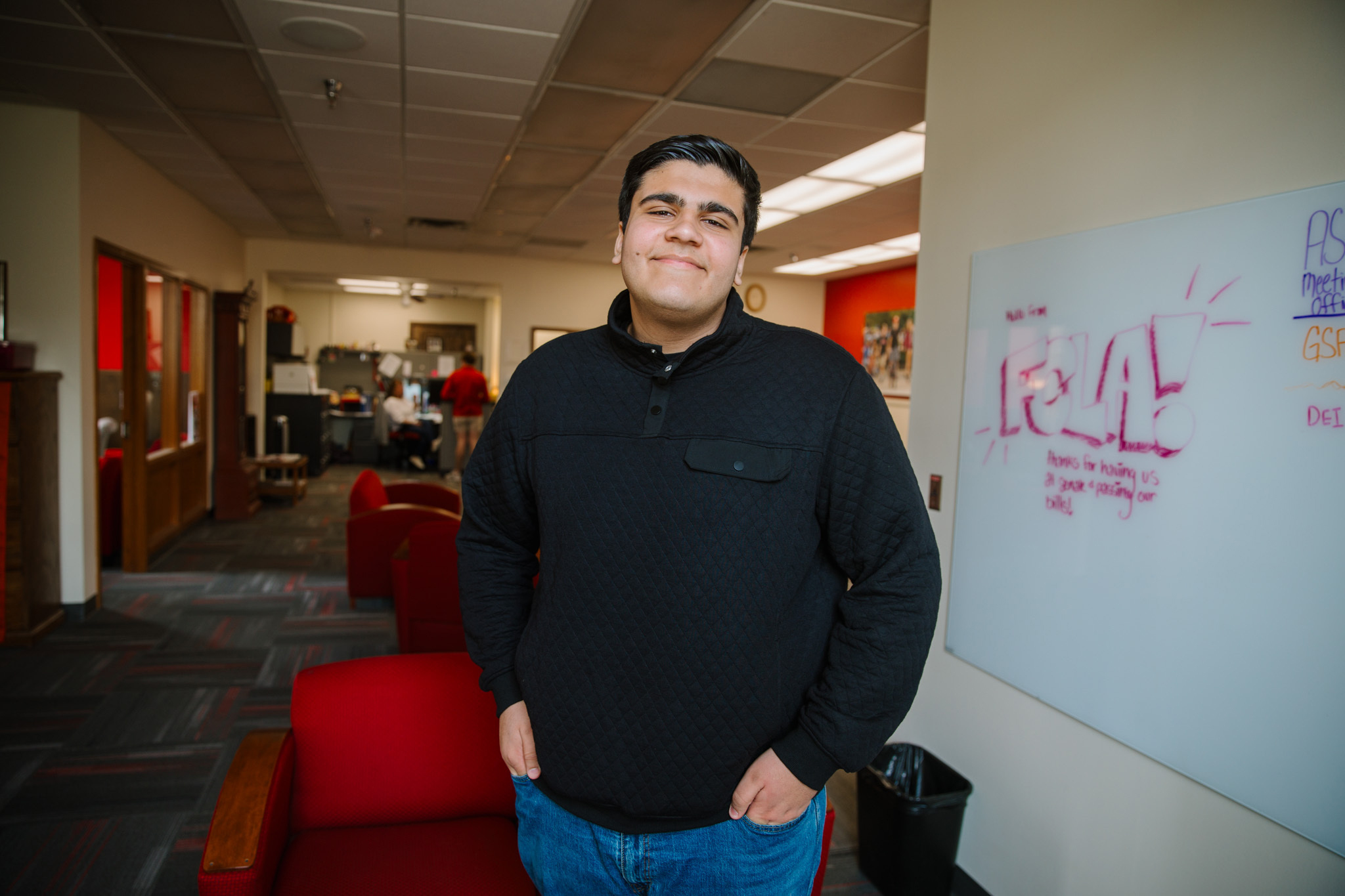 Zein Saleh stands in an office.