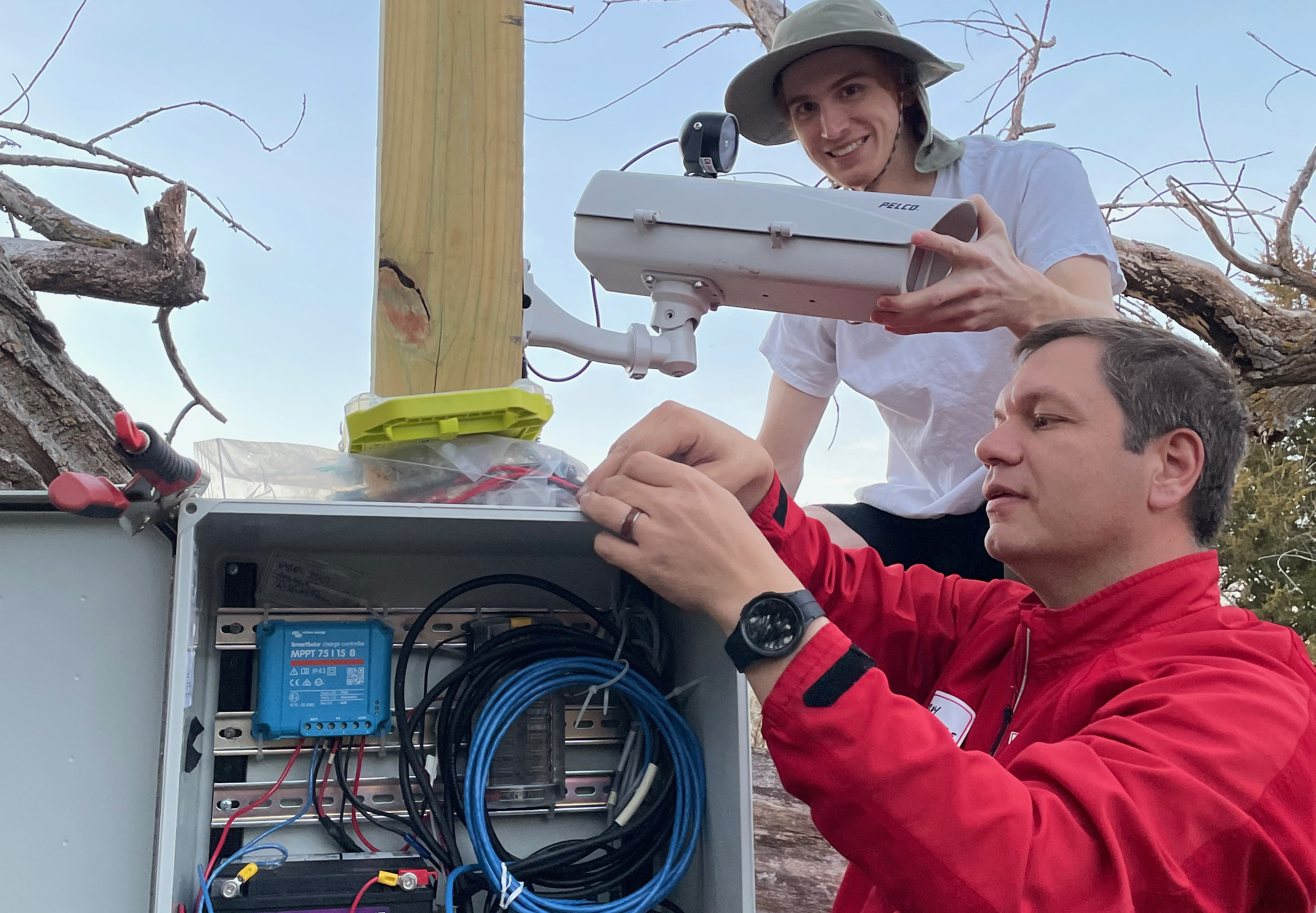 Troy Gilmore and Chris Terry work on a U.S. Geological Service camera.