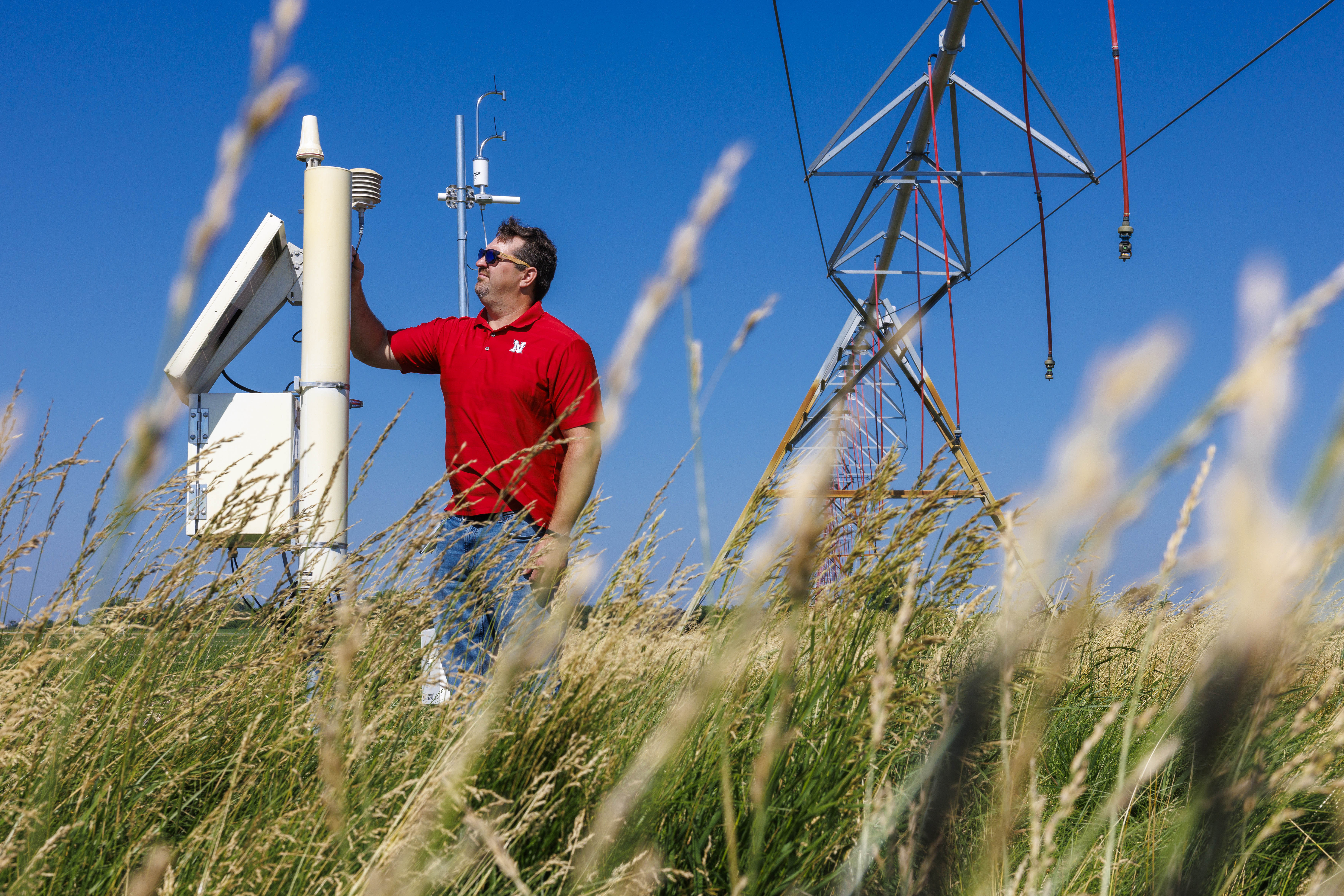 Trenton Franz inspects one of the cosmic ray neutron sensors at UNL's Eastern Nebraska Research, Extension and Education Center near Mead.