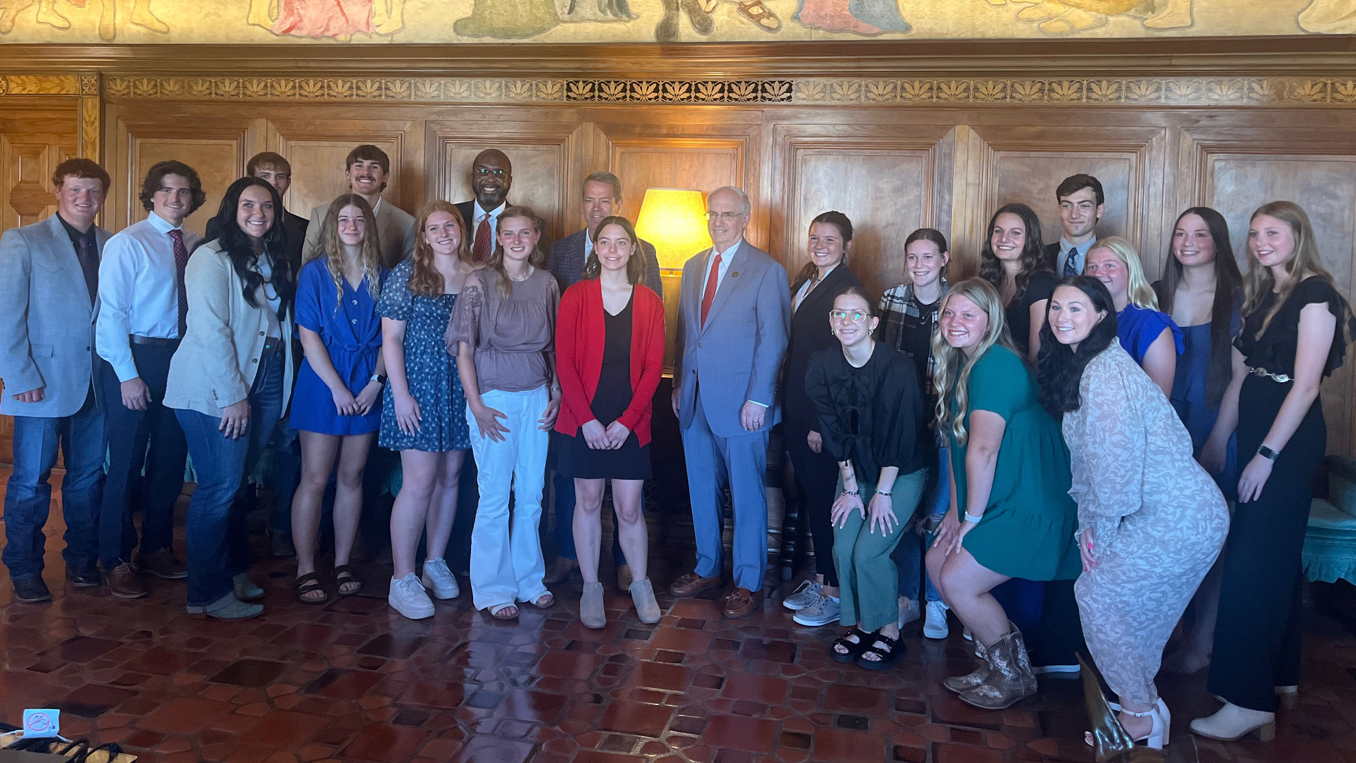 Nineteen University of Nebraska–Lincoln students pose with Chancellor Rodney D. Bennet, Nebraska Gov. Jim Pillen and University of Nebraska system President Dr. Jeffrey P. Gold inside the Nebraska State Capitol.