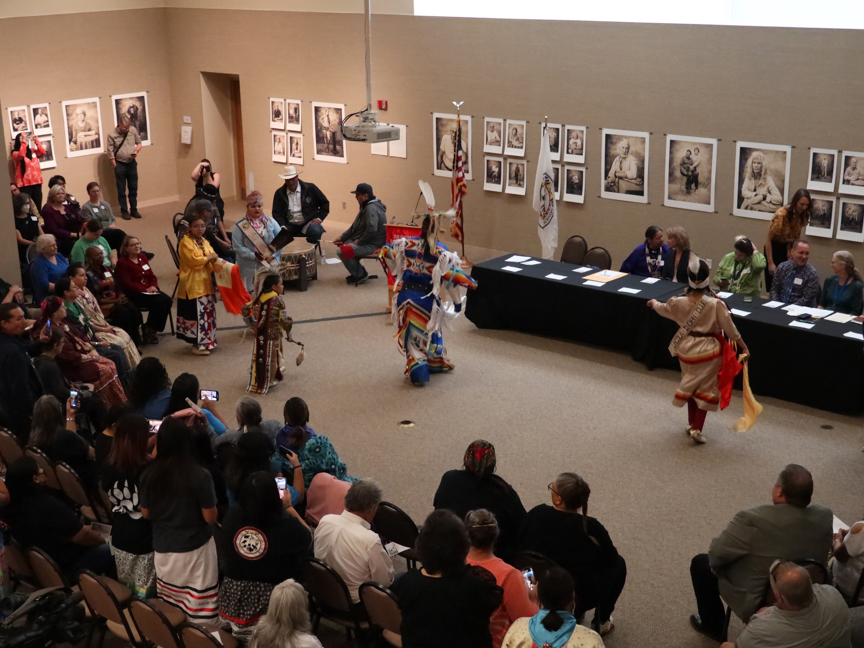 Native dancers perform in front of a crowd at the Center for Great Plains Studies.