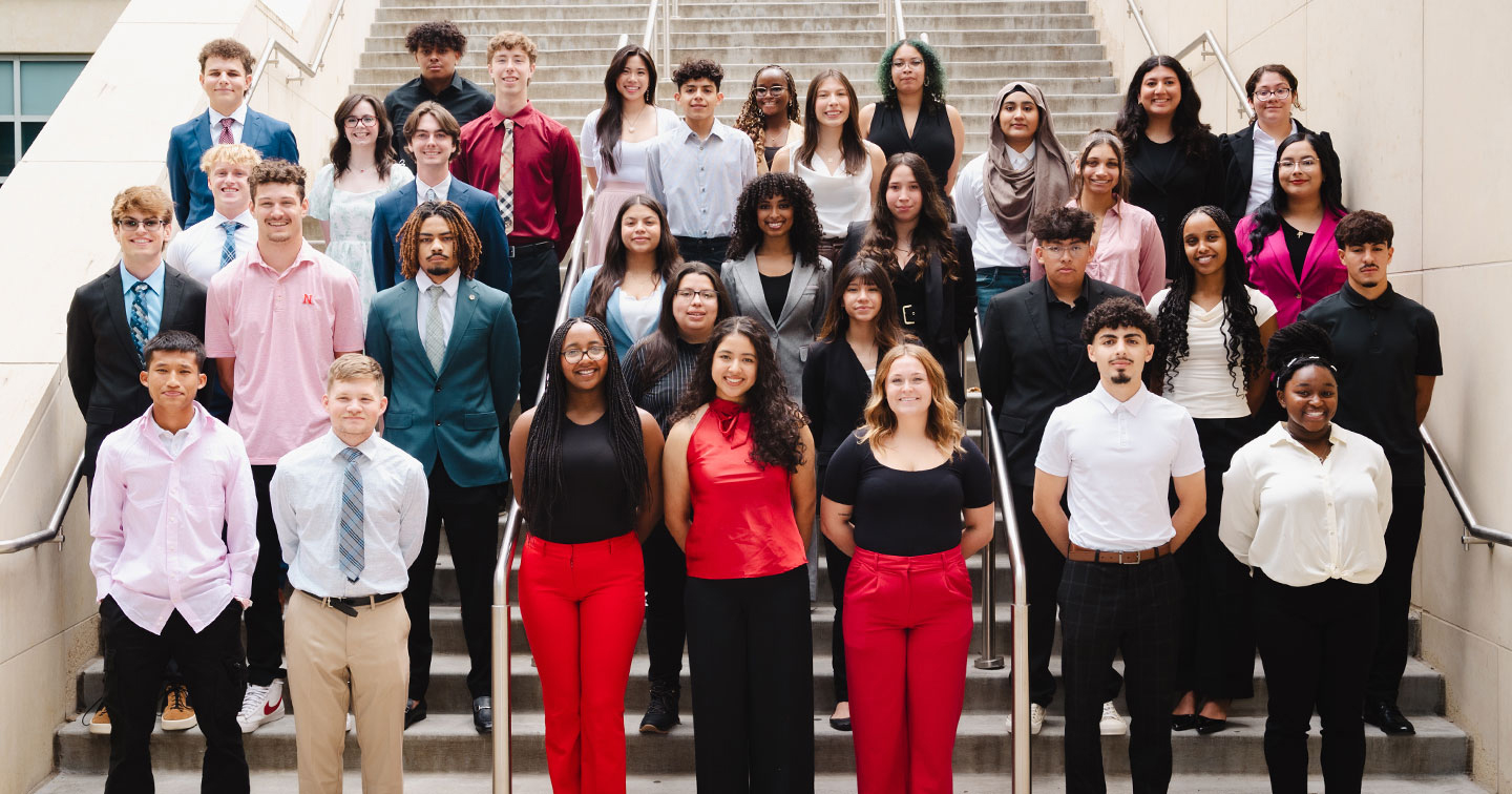 Thirty-four members of the 2024-25 Inclusive Business Leaders cohort pose for a photo on a staircase.