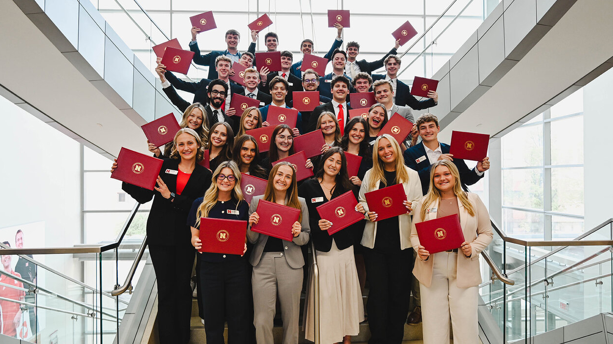 Dozens of Husker students on a staircase in Howard L. Hawks Hall.