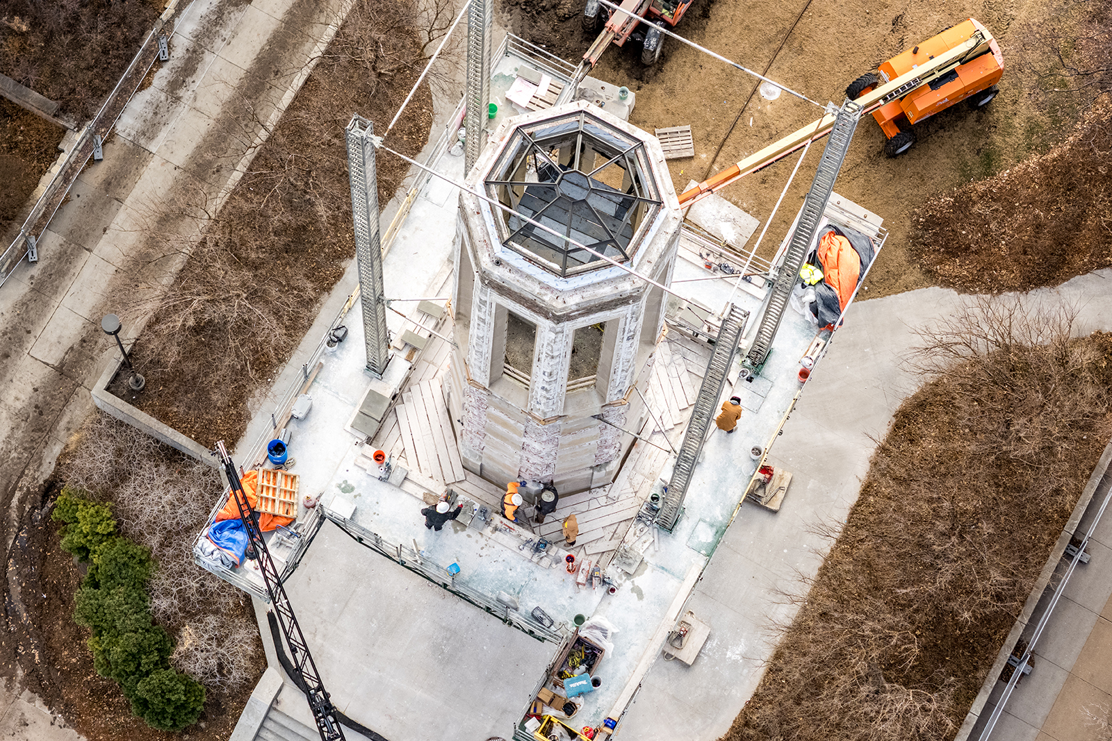 Aerial view of construction workers placing stones on Mueller Tower.