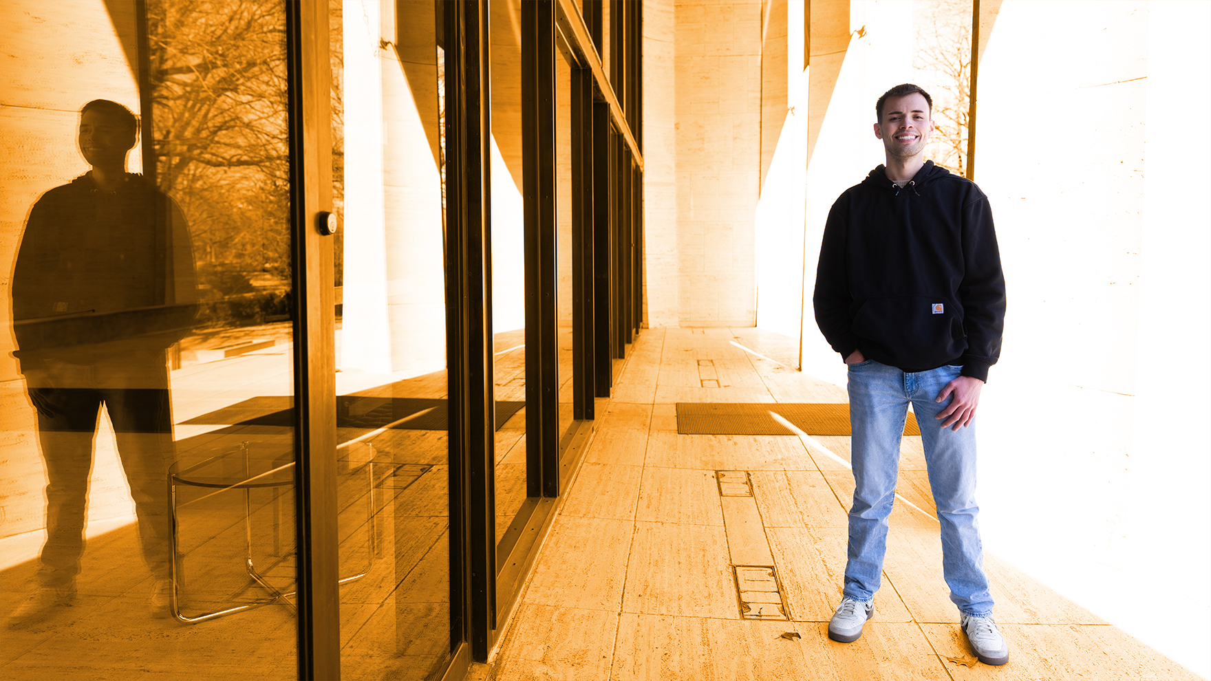 Nebraska's Randall Nunez stands on the steps outside Sheldon Museum of Art.