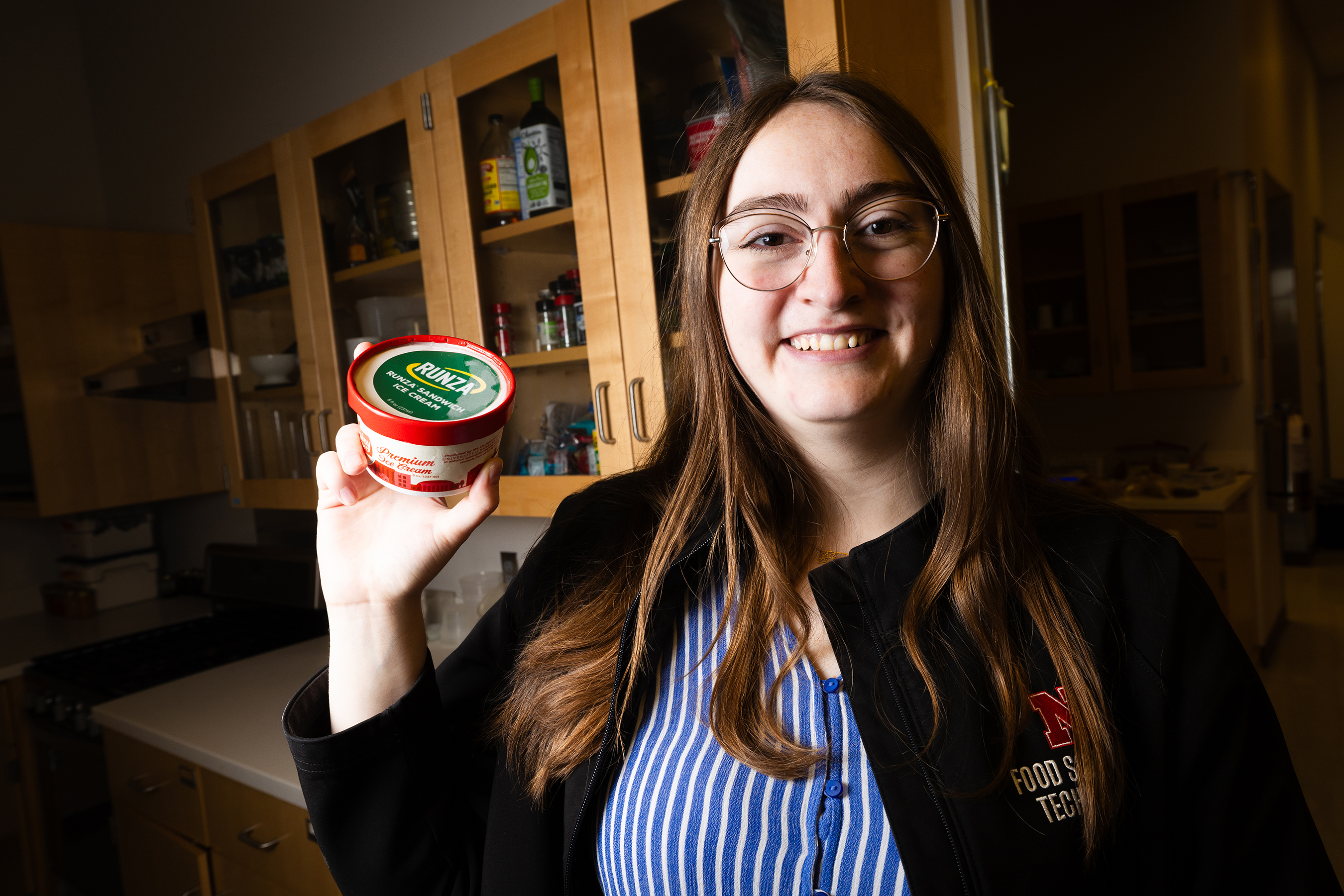 April Johnson, product development project manager in the Food Processing Center, poses with a container of Runza-flavored ice cream in the product development lab. Johnson led development of the limited-release frozen treat, which contains Runza's unique spice blend, cabbage flavor and pie dough in place of bread.