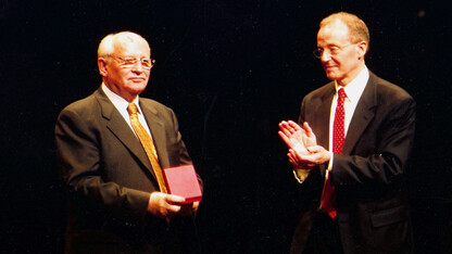 Chancellor Harvey Perlman (right) claps after presenting a Cather Medal to Mikhail Gorbachev during a 2003 E.N. Thompson Forum lecture at the Lied Center for Performing Arts.