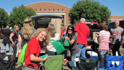 A volunteer from the "Go Green for Big Red" hands out a recycling bag during a Husker home football game. Volunteers are being sought for the 2016 season.