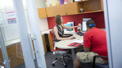 Jaci Gustafson advises a student in Nebraska's Explore Center. The center is the academic advising home for students who are undecided on a major, transitioning between majors, pre-health or pre-law.