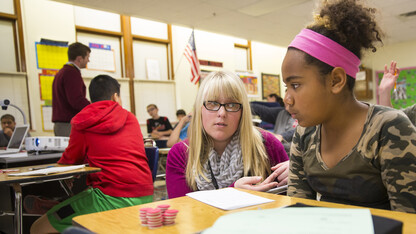 Megan Jorgensen, a Nebraska student teacher in 2014, works with a sixth grader at Park Middle School. A university research team is examining how experienced educators can act as coaches, providing feedback to teachers and enhance classroom performance.
