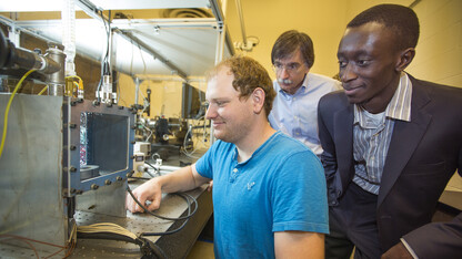 Corey Kruse, (from left) an engineering graduate student, shows a part of his research to faculty members George Gogos and Sidy Ndao. Kruse received a 2014 NASA Space Technology Research Fellowship.