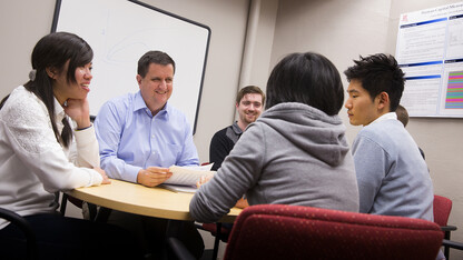 Eric Thompson (second from left), associate professor of economics and head of the Bureau of Business Research, works with student research assistants.
