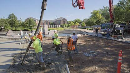 A crew of nearly 20 construction workers work concrete poured in the Union Plaza on City Campus on July 31. UNL schedules most concrete replacement projects between early July and late August, which is a time when there is less activity on campus.