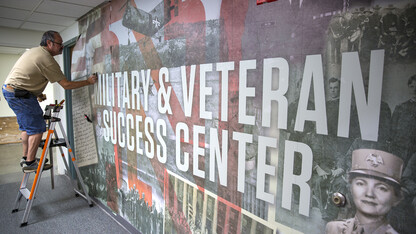 Dave Godin of Renze Display installs a wall mural outside of UNL's new Military and Veteran Success Center in the Nebraska Union. The office, which will offer support to student veterans, members of the military and their dependents, opens Sept. 11.