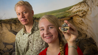 Carissa Raymond (right) holds fossilized teeth of a multituberculate mammal, a small rodent-like creature that lived at the end of the dinosaur’s era. During summer 2014, Raymond found a similar fossil later identified as a previously unknown multituberculate species while on a dig in New Mexico. Ross Secord (left), associate professor of earth and atmospheric sciences, led the dig.
