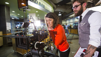 Nebraska's Amanda Christi and Andrew Swenson film a recruitment video in the Abel-Sandoz Dining Center. The admissions duo also led Nebraska's production of the "In Our Grit, Our Glory" institutional spot.