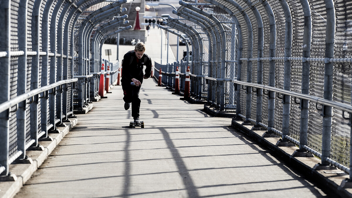 A skateboarder accelerates up the 10th Street pedestrian bridge. The walkway will be closed for a maintenance project on Feb. 20.
