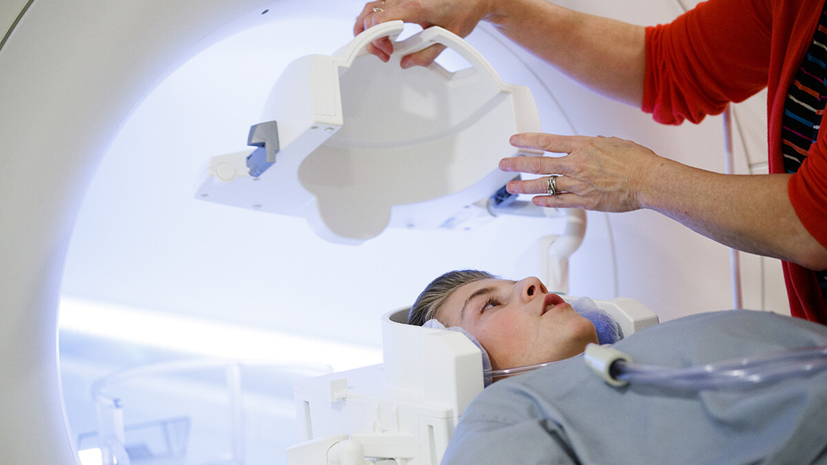 A boy gets placed in an MRI machine.