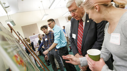 Catherine Berrick explains her research project on Nebraska bats to District 4 Sen. Robert Hilkemann. State senators were invited to a special research poster session held at the Nebraska State Capitol on March 30.
