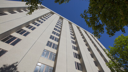The 13 floors of Cather Hall stretch upward along 17th Street at the University of Nebraska–Lincoln. Both Cather and Pound halls as well as the dining complex between the two towers are being demolished.
