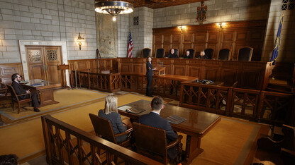 Nebraska Law student Maureen Larsen (center) makes a point before Nebraska Supreme Court Justices (from left) William B. Cassel, Michael G. Heavican and Stephanie Stacy during the 2018 Thomas Stinson Allen Moot Court Competition. The Nebraska Law program was recently counted among the nation’s best in terms of graduates earning jobs.