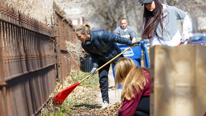 Keeleigh Thayn (in blue jacket) and her Gamma Phi Beta sorority sisters rake leaves along P street during the Big Event on April 7. More than 3,000 students, faculty and staff participated in the day of service.