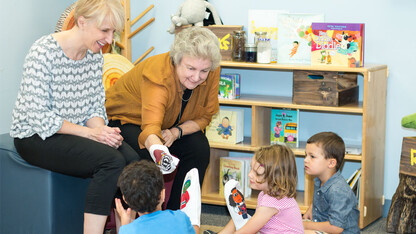 From right, Gwen Nugent, CYFS research professor, and Kathleen Rudasill, professor of educational psychology and associate dean for research and faculty development at Virginia Commonwealth University, introduce children to a few of the puppet characters 