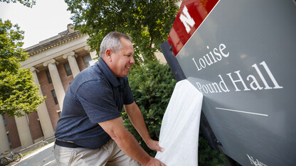 Bob McRoberts of SignsNow finishes applying the name to the newly renovated Pound Hall on Aug. 11. Named in honor of Louise Pound, the building was formerly known as the College of Business Administration and Social Sciences Hall. It is located at 12th and R streets.