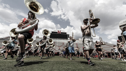 Members of the Cornhusker Marching Band practice on Tom Osborne Field in Memorial Stadium. The band's annual exhibition is Aug. 17.