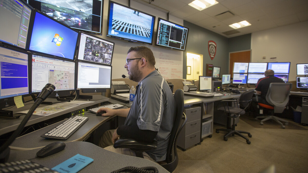 .Zach Fischer (left) and Jonathan Gentert work in the University Police dispatch center during the nigh shift on Oct. 4-5.