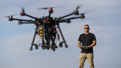 Nebraska's Adam Plowcha pilots a drone that is being developed to drill holes and place sensors in soil. The vehicle has multiple applications, from agriculture to national defense.