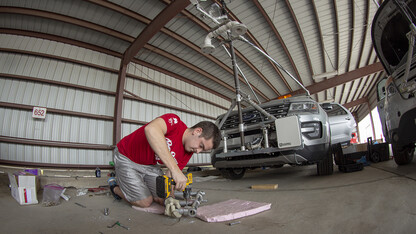 Graduate student Alex Erwin drills a pipe that will hold an instrument cluster on Nebraska's newest storm chase vehicle. Starting this spring, 13 Huskers will be part of TORUS, a national study designed to collect data about how severe storms and tornadoes are formed.