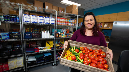 Morgan Smith, graduate research assistant, holds a tote of fresh vegetables at the Husker Pantry in August 2019.