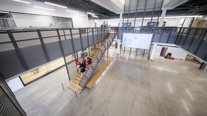 A group of students walk down the stairs in the atrium of the new Johnny Carson Center for Emerging Media Arts. The open area will feature moveable walls to create flexible spaces once all the furniture arrives.