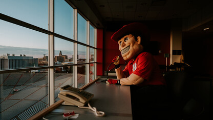 Herbie Husker practices his play-by-play skills in the Memorial Stadium press box. Herbie will be honored during the Sept. 17 Celebration of Service for his 45th years as the university mascot.
