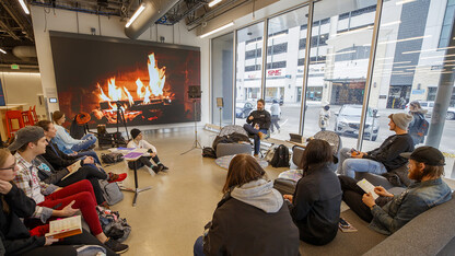 With a fireplace in the background, faculty Jesse Fleming leads a discussion in a Visual Expression Studio course in Nebraska’s Johnny Carson Center for Emerging Media Arts. The facility, which is in its first semester of use, will be celebrated Nov. 15-17.