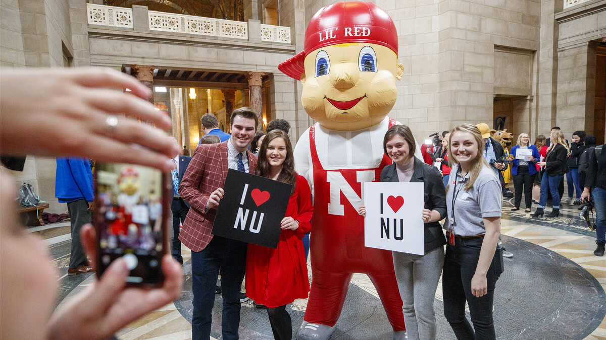 Lil' Red poses with UNL students in the rotunda. NU Advocacy Day at the Capitol. March 10, 2020. 